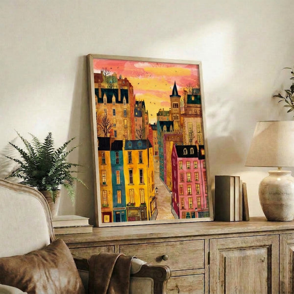 Folk art watercolor painting of a historic town street in coral, golden, and teal tones, complete with a towering castle and birds soaring overhead, creating a warm and dreamy nostalgic mood.