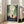 Modern take on Little Red Riding Hood with minimalist forest scene, mysterious wolf companion, and castle backdrop in soft greens, warm cream, and deep charcoal framed poster.