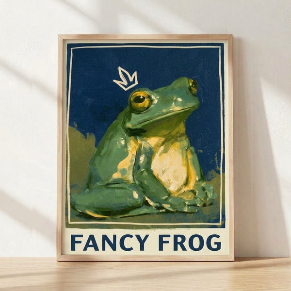 Vintage Art Nouveau framed poster depicting an ornately crowned frog in navy blue, sage green, and gold tones with a whimsical yet dignified character against a cream background.