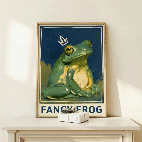 Whimsical framed art print showcasing a regal frog wearing an elaborate crown in rich navy and gold, rendered in nostalgic Art Nouveau style with soft sage and cream hues.