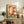 Framed poster art in retro style depicting a chic goose at a wine party with sunglasses, cheese, and crackers in a whimsical palette of tan, cream, and forest green.