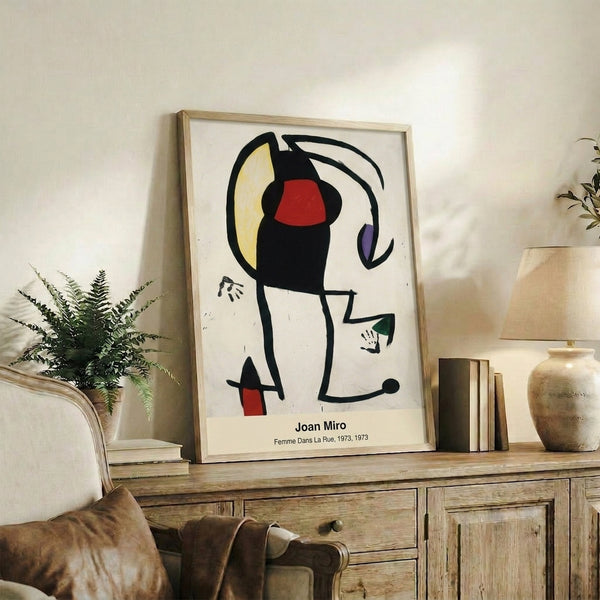 Modernist abstract framed print featuring organic geometric shapes in primary colors and black, suggesting a female figure in surrealist style with dreamlike, lighthearted mood.