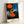 Surrealist wall art poster showing an abstracted figure in black and red silhouette facing a radiant yellow sun, evoking powerful emotional tension through bold color contrasts.