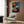 Wall art featuring an abstracted female figure gazing toward a glowing celestial orb, rendered in soft warm colors with organic and linear mark-making.