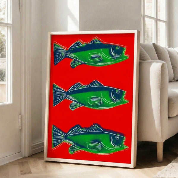 Framed art print featuring a stylized red fish in pop art tradition, bold graphic design with striking warm color palette.