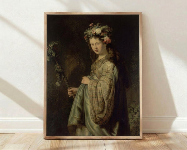 Framed Rembrandt Flora portrait painting depicting a goddess figure in rich golden and warm earth tones, classical museum art print for living room decor.