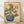 Serene Japanese woodblock-style art print of a delicate azalea bonsai tree in a cobalt blue pot, rendered in soft cream, crimson, and forest green tones on a cream background.
