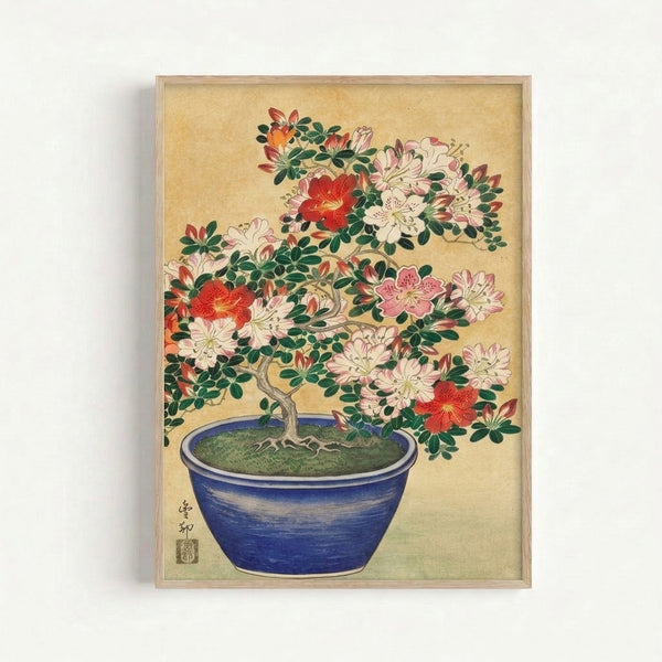 Framed Japandi wall art depicting a refined bonsai with pale pink azalea blooms and lush foliage, printed in traditional woodblock aesthetic with cobalt and cream palette.