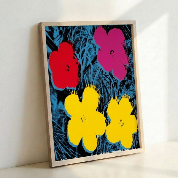 Framed pop art flowers print displaying stylized botanical forms in vivid, contrasting colors on gallery wall.