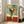 Framed modern floral artwork featuring a striking vase filled with vivid, loosely rendered blooms in a sophisticated color harmony of contrasting hues.