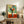 Abstract botanical poster displaying an expressive bouquet of flowers in a decorative vase, combining bold color choices with gestural, painterly mark-making.