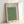 Minimalist framed poster depicting birds soaring across a zen landscape with temple architecture, in soft sage green and charcoal hues.