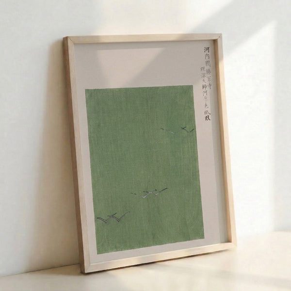 Minimalist framed poster depicting birds soaring across a zen landscape with temple architecture, in soft sage green and charcoal hues.