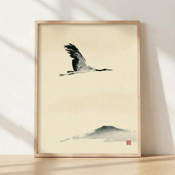 Serene Japanese sumi-e ink painting of a flying crane with minimalist mountain landscape in black, gray, and sage green on cream background, framed as zen wall art.