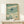 Framed art print featuring a solitary bird soaring over calm coastal waters, rendered in muted sage, cream, and charcoal in the style of traditional Japanese woodblock prints.