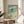 Serene coastal-themed poster with a lone swallow in flight, incorporating Japanese woodblock aesthetics and a calming palette of sage green, cream, and charcoal tones.