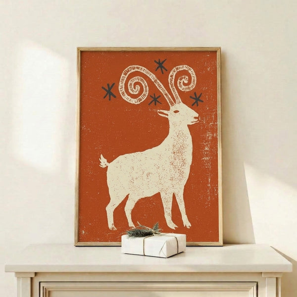 Boho-inspired folk art print of an ibex goat adorned with geometric horns and a celestial star motif, displayed in warm rust orange and navy tones with earthy speckled details.