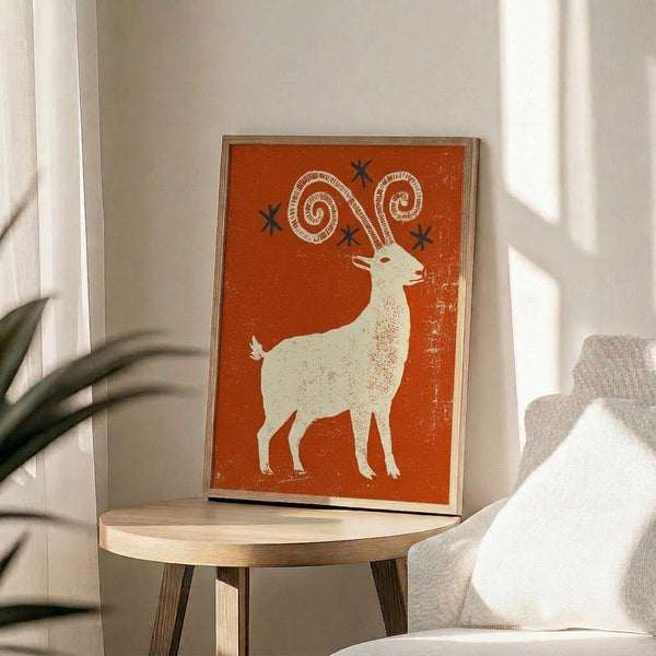 Whimsical retro animal art print showing a stylized ibex goat with prominent horns and star imagery in rust orange and cream, capturing folk art charm with textured boho aesthetics.