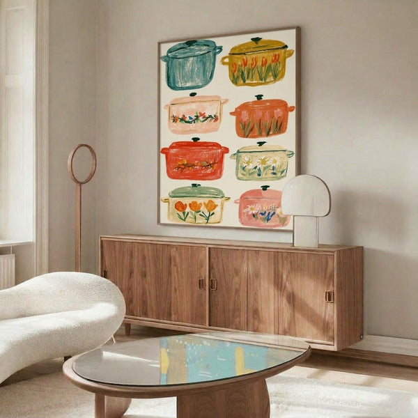Framed folk art illustration of charming Dutch ovens brimming with blooming flowers in soft coral, teal, and cream hues, radiating domestic warmth and countryside coziness.