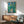 Forest landscape artwork in restrained, naturalistic tones of green, tan, and gray, with a calm, introspective mood suitable for office or home decor.
