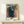 Contemplative modern poster with layered human silhouettes representing life's progression, painted in muted browns, greens, and touches of gold.