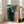 Framed wall art in impressionist style showing shadowy figures across different ages, with a melancholic palette of blue, ochre, and earthy browns.
