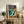 Zen-inspired woodblock art depicting four birds with expressive eyes and flowing feathers in a minimalist style, displaying warm rust and orange accents against cool grey-blue and cream hues.