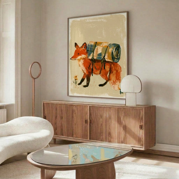 Whimsical framed watercolor poster depicting a fox carrying camping gear and flowers, rendered in cottagecore folk art style with creamy and mustard tones.