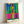 Minimalist wall art displaying organic abstract forms in cheerful warm and cool tones—orange, blue, yellow, and green—against a clean white background with a modern cut-out aesthetic.
