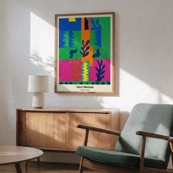 Framed modern poster showcasing vibrant geometric cut-outs in warm orange, bright blue, cheerful yellow, and green set against white—a joyful, decorative abstract composition.