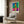 Abstract wall art featuring organic cut-out shapes in orange, blue, yellow, and green tones arranged in a minimalist, uplifting design inspired by modernist collage principles.