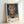 Distorted figurative portrait in cream, slate blue, and dusty rose palette with gestural brushwork; abstract framed artwork with psychologically charged atmosphere.