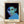 Pop art portrait of a man with a contemplative expression, rendered in muted green, blue, and black tones on a white background, framed as a modern minimalist print on a wall.