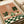 Whimsical home decor print showing a frog luxuriating in bathwater with lush plants and geometric tiles, rendered in a soft palette of sage green, cream, and warm earth tones.