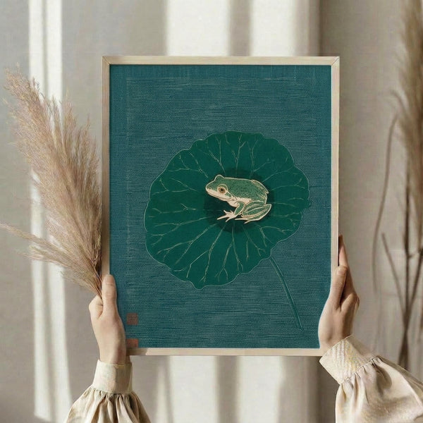 Contemplative nature-inspired line art poster featuring a green frog on a lily pad in the style of traditional Japanese woodblock prints, with teal and cream tones creating a peaceful mood.