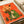 Charming botanical wall art depicting a whimsical frog presenting a daisy bouquet in retro style, with a warm palette of coral red, pale yellow, and forest green tones.