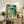 Framed art print showing contemplative frog and lily pond composition in traditional Ukiyo-e aesthetic with naturalistic palette of blues and greens.