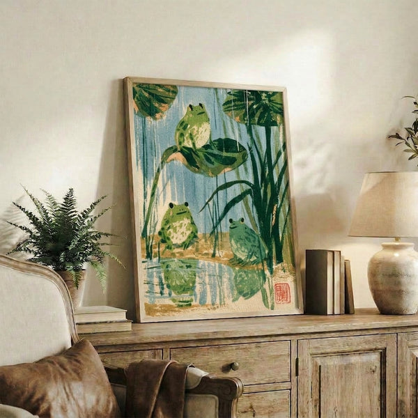 Framed art print showing contemplative frog and lily pond composition in traditional Ukiyo-e aesthetic with naturalistic palette of blues and greens.