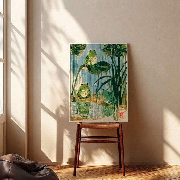 Serene nature-themed framed print depicting frogs in a lily pond surrounded by aquatic vegetation, executed in the Japanese woodblock style with calming blue and green hues.