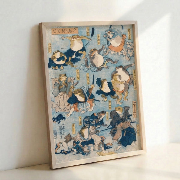 Framed woodblock-print style artwork depicting a comedic frog samurai character adorned in a decorative kimono, striking a dramatic pose with sword and folding fan in muted earthy hues.