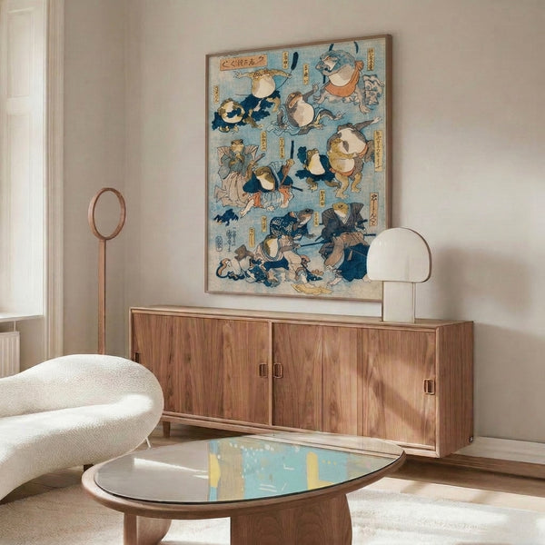 Japanese-inspired woodblock poster displaying a playful armored frog samurai with elaborate kimono details, sword, and fan rendered in pale blue, cream, and navy with burnt orange highlights.