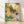 Serene watercolor painting of a bird perched among blooming garden flowers and lilies in soft orange, pink, and forest green tones, framed as wall art.