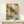 Japandi-style botanical watercolor print featuring a graceful bird nestled in flowering plants with lavender and cream accents, displayed as framed wall decor.