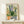 Cheerful botanical watercolor art print displaying terra-orange and golden-yellow wildflowers in ceramic pots against a cream background, blending Japandi aesthetic with homey garden appeal.