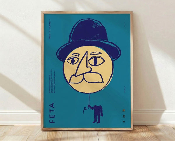 Retro Bauhaus poster featuring a surreal face with a bowler hat and single eye, framed on a wall in turquoise, navy blue, and cream tones.