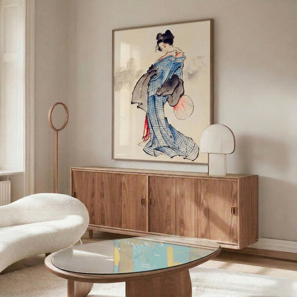 Elegant framed Asian art print in classic woodblock style: geisha in blue checkered robe with fan, soft cream and coral tones against black outlines, graceful and poised.