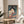 Framed poster showcasing a mysterious Noh-masked woman with flowing fabric and cherry blossoms, executed in traditional woodblock style using slate gray, coral, cream, and deep blue pigments.