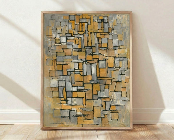 Abstract Bauhaus poster with geometric shapes in gold, gray, and cream on a white background, framed on a wall.
