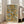 Art Deco-inspired framed print with abstract rectangular forms in gold, black, and gray creating an understated sophisticated aesthetic.