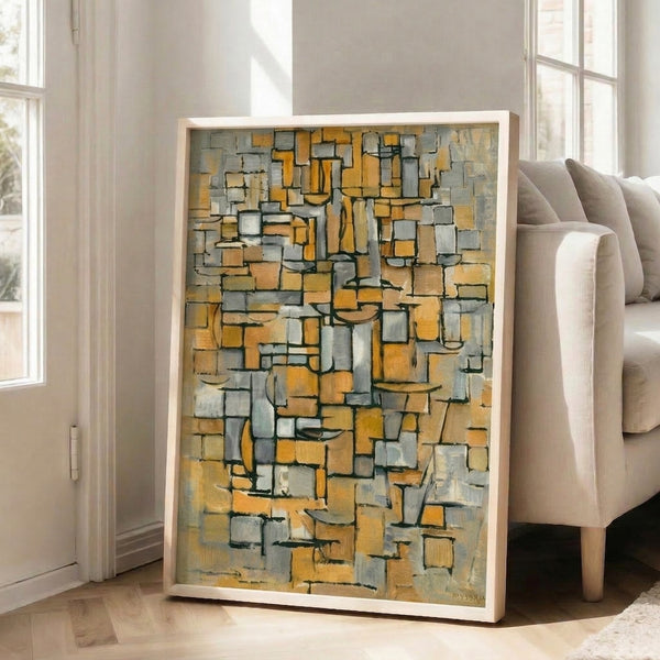 Art Deco-inspired framed print with abstract rectangular forms in gold, black, and gray creating an understated sophisticated aesthetic.